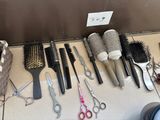 many different types of hair brushes and combs laid out on the floor
