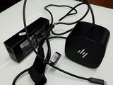 a white table with a black box and a charger on it