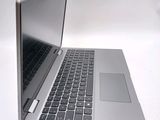 a silver laptop computer sitting on top of a white table