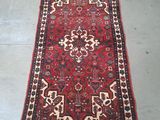 rug on the floor is red and white with a pattern on it