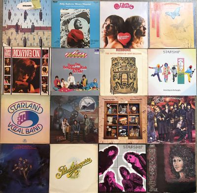 many different album covers on the wall of a room