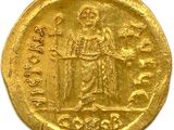 an image of a gold coin with an image of a man holding a staff