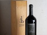 a bottle of wine sitting next to a box on a table