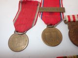 two medals and a medal on a white surface