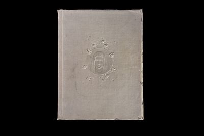an old book with a picture of a coat of arms on it