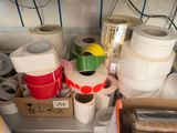 many rolls of tape sitting on a shelf in a room