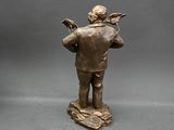 bronze statue of a man with a bird on his shoulder