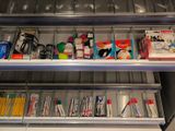 two shelves with pens, pencils, and other office supplies on them