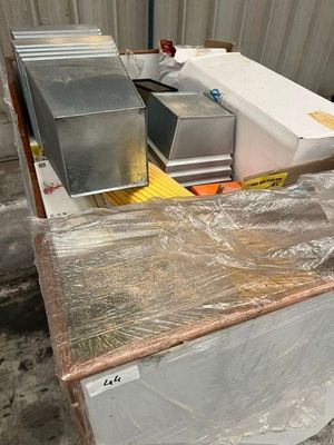 a pile of boxes sitting on top of a pallet in a warehouse