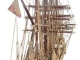 a wooden model of a ship on a white background