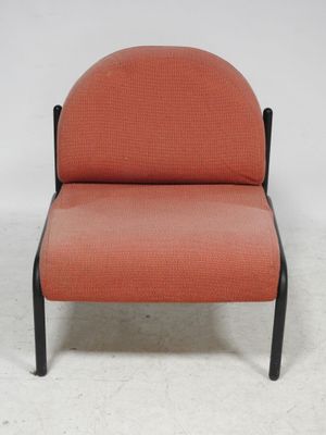 an orange chair with black legs and a black frame