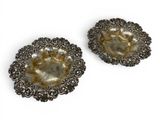 a pair of silver plated dishes on a white background