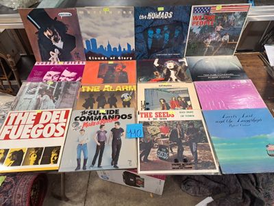 a lot of vinyl records on a table in a room