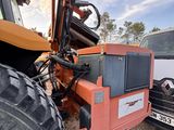 a tractor that is parked next to a truck
