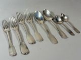 a lot of silver spoons and forks on the table