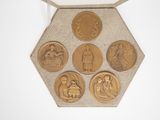a gold medal with four medallions on it