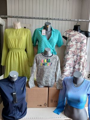 several mannequins and dresses are on display in a clothing store