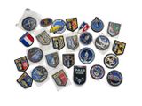 a lot of different military patches on a white surface