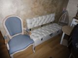 a couch and a chair in a room with a wooden floor