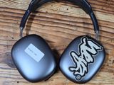 headphones on a wooden table with a black case and a white sticker on it