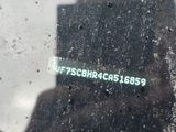 reflection of a person in a car window with a sticker on it