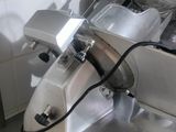 a picture of a kitchen counter with a meat slicer on it