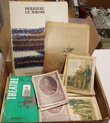 many books in a box on a table