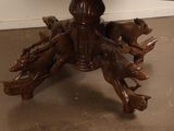a wooden table with carved animals on top of it