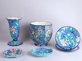 many different pieces of blue and pink pottery on the table