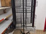 a black bird cage on a stand in a store
