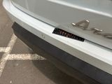 a close up of a car ' s rear bumper with a sticker on it