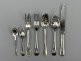 five forks, a knife, and a spoon on a table
