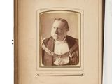 an old photo of a man in a suit and tie in a book