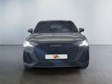 the front view of a grey car in a showroom