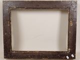 an old picture frame with a small hole in the middle of it
