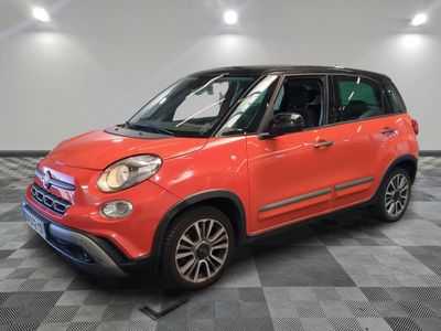 a red fiat car is parked in a room with a checkered floor