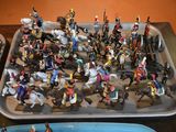 a lot of figurines on a tray on a table