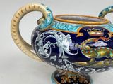 a blue and yellow vase with a dragon on it