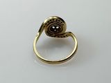 a close up of a gold ring with a black stone on it
