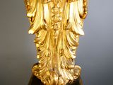 an image of a gold statue of a woman holding a baby