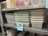a shelf with plastic containers on it in a store