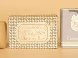 an image of a bottle of perfume next to a soap and soap bar