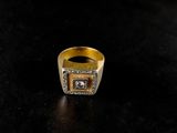 a close up of a gold ring on a black surface