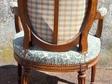 a wooden chair with a plaid upholstered seat