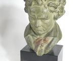 sculpture of a bust of a boy with curly hair on a black base
