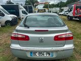 a silver car that is parked in the grass