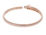 a rose gold cuff bracelet with a single black diamond