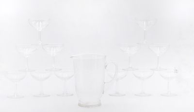 a lot of wine glasses and a pitcher on the table