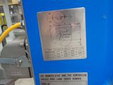 a blue machine that is sitting in a factory