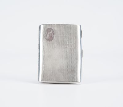 un étui à cigarettes en argent orné d'un monogramme sur le devant
